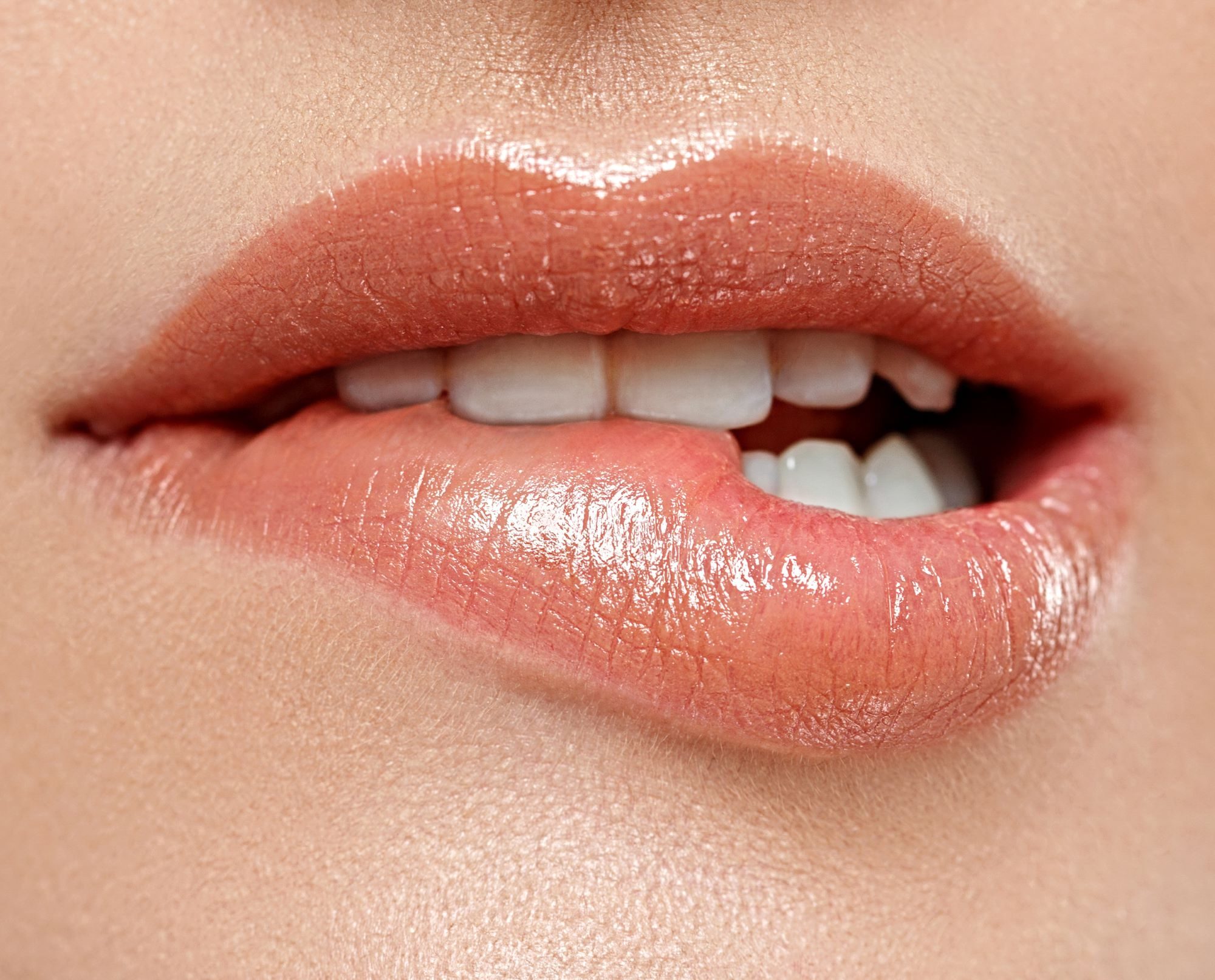 Closeup of a woman seductively biting her lower lip after having lip blushing in West Palm Beach